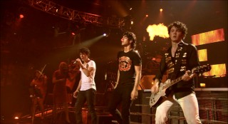Fireballs and red lighting remind us this is the Burning Up tour.