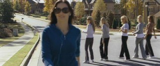 Kate (Demi Moore) struts her stuff both literally and figuratively as her peers check out her new jumpsuit.