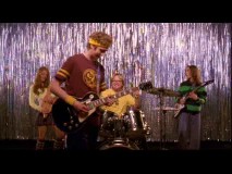 The three young leads, joined by a bespectacled blond drummer, rock out to OK Go in the Cast and Crew Jam.