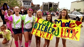 In every city, hordes of Beliebers gather to show their appreciation for Justin Bieber with customized clothing and poster board.