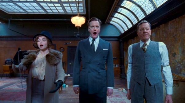 Queen Elizabeth I (Helena Bonham Carter) joins in her husband's (Colin Firth) speech therapy with Lionel Logue (Geoffrey Rush).