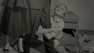 Gaby Rodgers clings to Mike Hammer's leg and looks up in the most suggestive of the Blu-ray's three navigated menu photos.