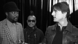 Tom Cruise expresses his appreciation for The Black Eyed Peas in this artistically black and white backstage footage.
