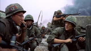 Private Cowboy (Arliss Howard, left) calls to request the assistance of a tank, while Animal Mother (Adam Baldwin, rear right) keeps watch with his rifle and our protagonist Private Joker (Matthew Modine, right) looks on. This image comes from the beginning of the film's climactic military finale.
