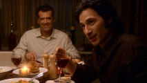 Mr. Trager (Bruce Thomas) is visibly amused to have the charismatic Michael Cassidy (Hal Ozsan) as his dinner guest.