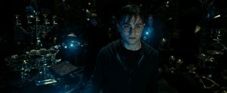 In darkness with wand lit, Harry Potter (Daniel Radcliffe) leads the search for Helga Hufflepuff's Cup.