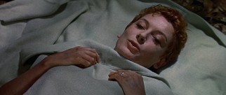 Recovering out of her habit, Sister Angela (Deborah Kerr) reveals a head of short red hair.