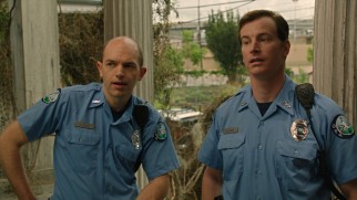Officers Huebel (Paul Scheer) and Sheer (Rob Huebel) investigate the Watsons with heavy suspicion.