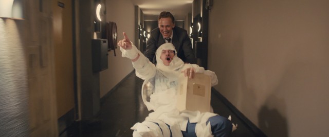 Dr. Laing (Tom Hiddleston) wheels a toilet paper-wrapped Richard Wheeler (Luke Evans) down the hall in the free-spirited times before things get mad in "High-Rise."