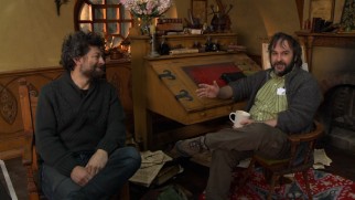 Sitting at Bilbo Baggins' desk, Peter Jackson and his Gollum/second unit director Andy Serkis discuss "New Zealand: Home of Middle-Earth."