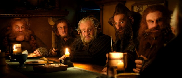 Hungry, hairy dwarves gather around Bilbo Baggins' table for an unexpected feast.