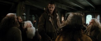 The widower Bard (Luke Evans) towers above his guests as a man among dwarves.