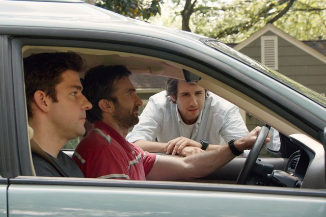 Reverend Dan (Josh Groban) awkwardly catches Ron (Sharlto Copley) and John (John Krasinski) spying on his family.