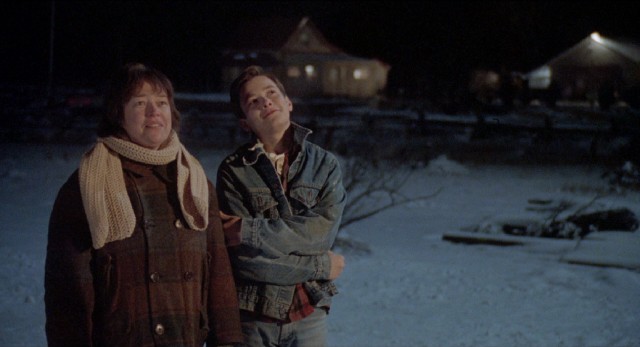 Mother (Kathy Bates) and eldest son (Edward Furlong) admire a home of their own on a winter's night in "A Home of Our Own."
