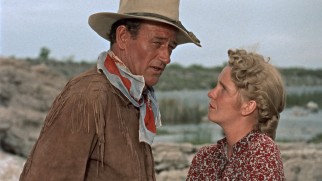Angie (Geraldine Page) may be a homely woman, but Hondo (John Wayne) might love her all the same.