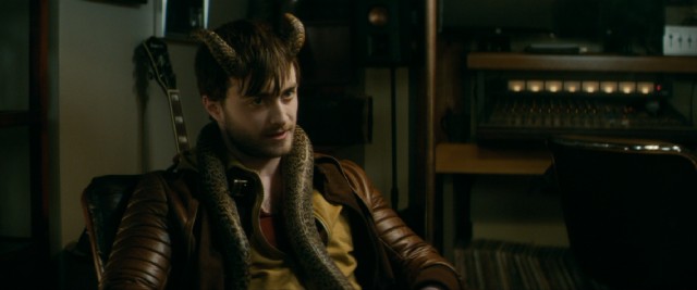 A snake slithers around the neck of Ig Perrish (Daniel Radcliffe) in "Horns."