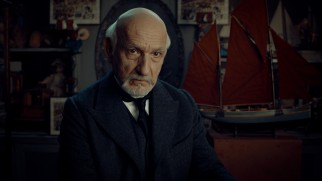 Georges Méliès (Ben Kingsley) confiscates Hugo's notebook and requires him to work in his toy shop to get it back.