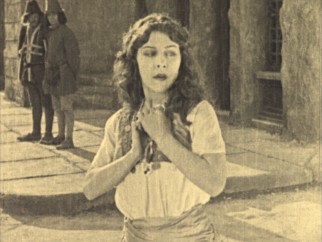 Dancing Gypsy Esmeralda (Patsy Ruth Miller) shows compassion for Quasimodo.