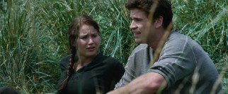 In volunteering for the Hunger Games, Katniss (Jennifer Lawrence) leaves her hunky friend Gayle (Liam Hemsworth) back home.