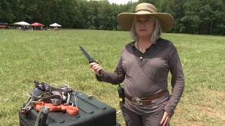 Prop master Trish Gallaher Glenn looks tough showing off "Weapons of the Arena."