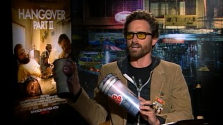 Miles Davis-Davidson (Rob Benedict) tries to get the true story of what happened in Bangkok, by questioning Justin Bartha on Big Gulp cups in the unauthorized documentary mockumentary.