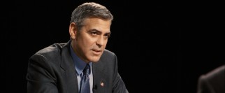 Presidential hopeful Governor Mike Morris (George Clooney) answers questions against the signature black backdrop of Charlie Rose.