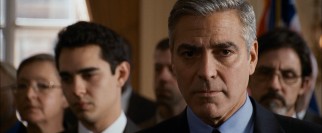 Governor Morris (George Clooney) receives a troubling phone call during a press conference.
