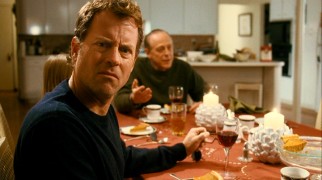 Richard (Greg Kinnear) just doesn't know how she does it. In this scene, "it" is dodging her family on Thanksgiving night to make work phone calls.