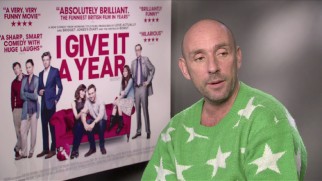 Writer/director Dan Mazer opts for a starry bright green sweater for his international interview conducted by the poster whose Jason Flemyng has been cut for the home video cover.