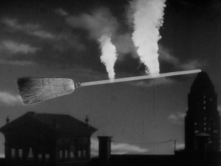 Still in smoke trail form, father and daughter witch share a broom ride, an optical illusion that explains some of the shot's wear and tear.