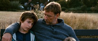 Anton (Mikael Persbrandt) lends an ear to his elder son Elias (Markus Rygaard).