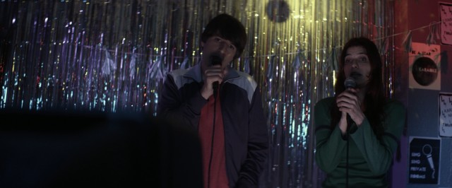 Louis (Demetri Martin) and Carol (Lake Bell) sing karaoke together in "In a World..."