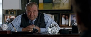 In one of his final film roles, James Gandolfini plays Doug Munny, the hotel owner who gives Burt and Anton their big break, and asks them to stay current.