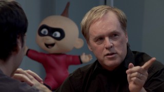 A happy Jack-Jack statue appears behind director Brad Bird in the new roundtable discussion "'The Incredibles' Revisited."