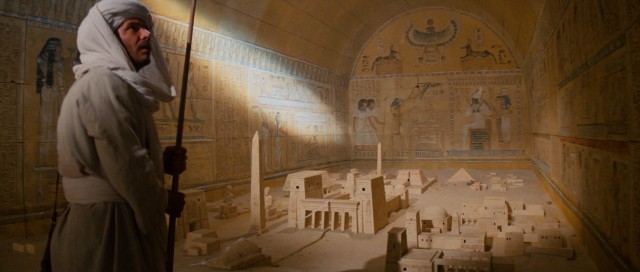 A disguised Indiana Jones (Harrison Ford) uses the Staff of Rah and sunlight to ascertain the location of the Well of Souls where the Ark of the Covenant is believed to be buried.