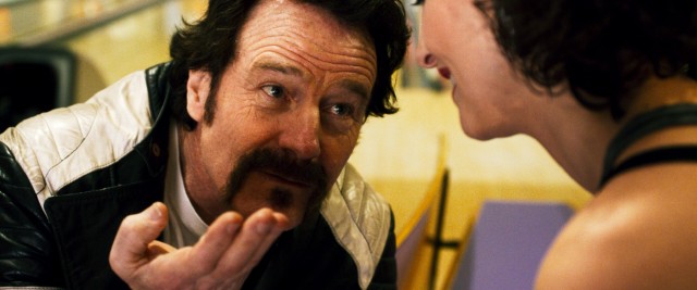 At the film's opening, undercover federal agent Robert Mazur (Bryan Cranston) has another alternate identity in the form of a drug-dealing hood.