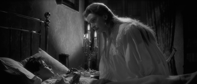Miss Giddens (Deborah Kerr) is troubled by the words and actions of Miles (Martin Stephens), one of two children to whom she is governess in "The Innocents."