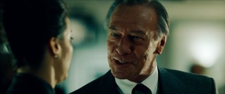 Mike Wallace (Christopher Plummer) schools one of CBS' high-powered lawyers (Gina Gershon) on manners.