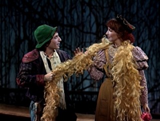The Baker's Wife (Joanna Gleason) shows her husband (Chip Zien) the hair as yellow as corn she got from Rapunzel.