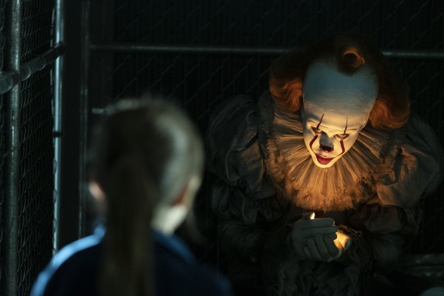 Pennywise (Bill Skarsgrd), the diabolical clown who torments Derry every twenty-seven years, lures in a girl with a birthmark under the football field bleachers.