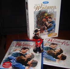 A photograph of the It's a Wonderful Life Gift Set contents: box, Blu-ray, booklet, and bell.