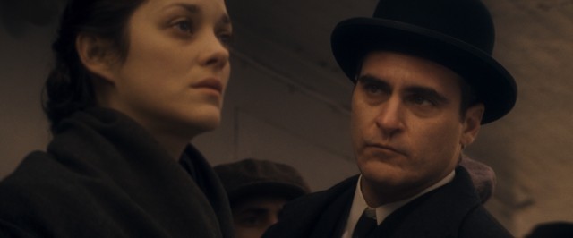 Bruno Weiss (Joaquin Phoenix) has his eye caught by Ewa Cybulska (Marion Cotillard), but the feeling is not mutual in James Gray's "The Immigrant."