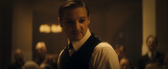 Emil (Jeremy Renner) captivates detained immigrants as Orlando the Magician.