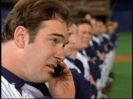 Steady Eddie Everett (Patrick Warburton) takes a cell phone call in the middle of the national anthem.