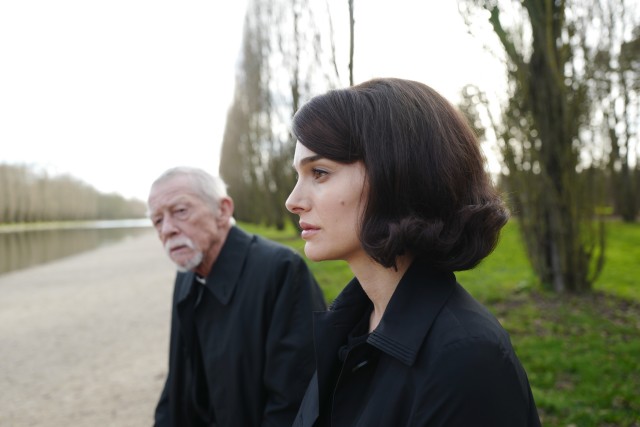 On the eve of her husband's funeral, a grieving Jackie Kennedy (Natalie Portman) talks to a priest (John Hurt) in "Jackie."