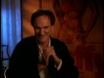Screenwriter/director Quentin Tarantino gives a lively interview in front of a poster for Pam Grier's "Coffy."