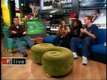 Carson Daly talks with Bridget Fonda, Pam Grier, and Quentin Tarantino on an MTV Live set festively decorated for Christmas 1997.