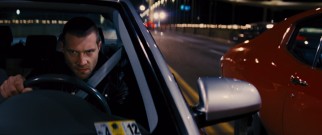 Charlie (Jai Courtney) and authorities pursues Jack Reacher in the obligatory car chase sequence.