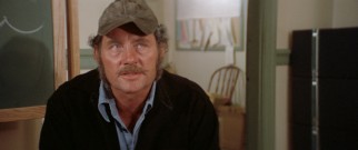 Quint (Robert Shaw) offers his expert shark hunting services for the hefty price of $10,000.