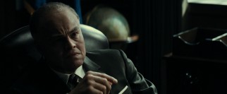 An older, fatter J. Edgar Hoover (Leonardo DiCaprio made-up) recounts his life experiences to young biographers.